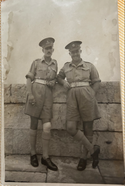 2 soldiers leaning against a wall